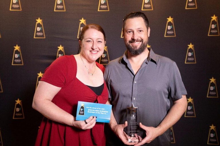 Ryan Adams & Kelly Adams accepting Business Excellence Award for RKA, August 2025